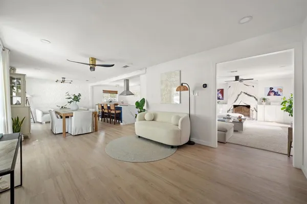 a living room with furniture and a wooden floor