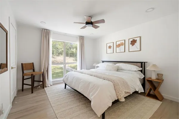 a bedroom with a bed and a large window
