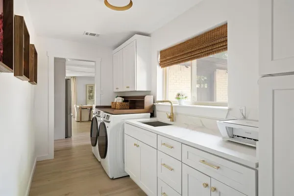 a kitchen with a sink cabinets and a window