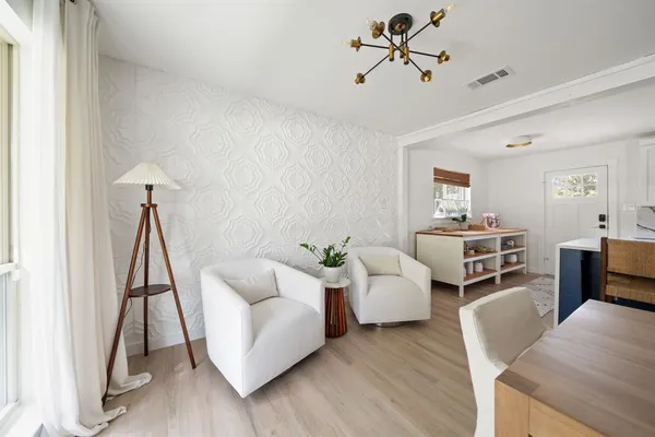 a living room with furniture a couch and a chandelier