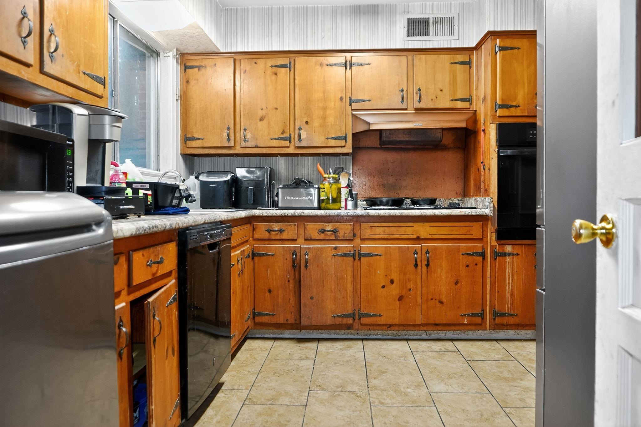 3034 Bannockburn Road Memphis, TN 38128 - Photo 1 of 18 a kitchen with stainless steel appliances granite countertop a stove top oven