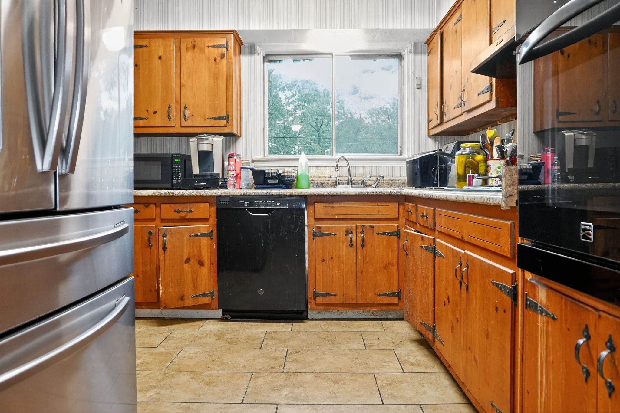 3034 Bannockburn Road Memphis, TN 38128 - Photo 9 of 18 a kitchen with stainless steel appliances granite countertop a refrigerator a sink dishwasher a stove and a dining table with wooden floor