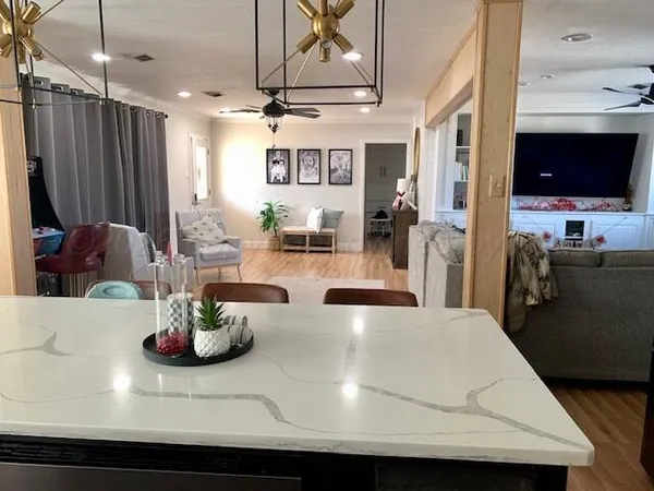 a view of a room with gym equipment and a flat screen tv