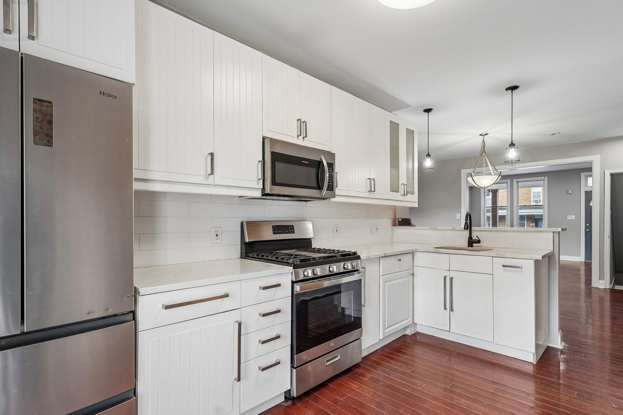 2817 Pelham Avenue Baltimore, MD 21213 - Photo 11 of 25 a kitchen with white cabinets and white appliances