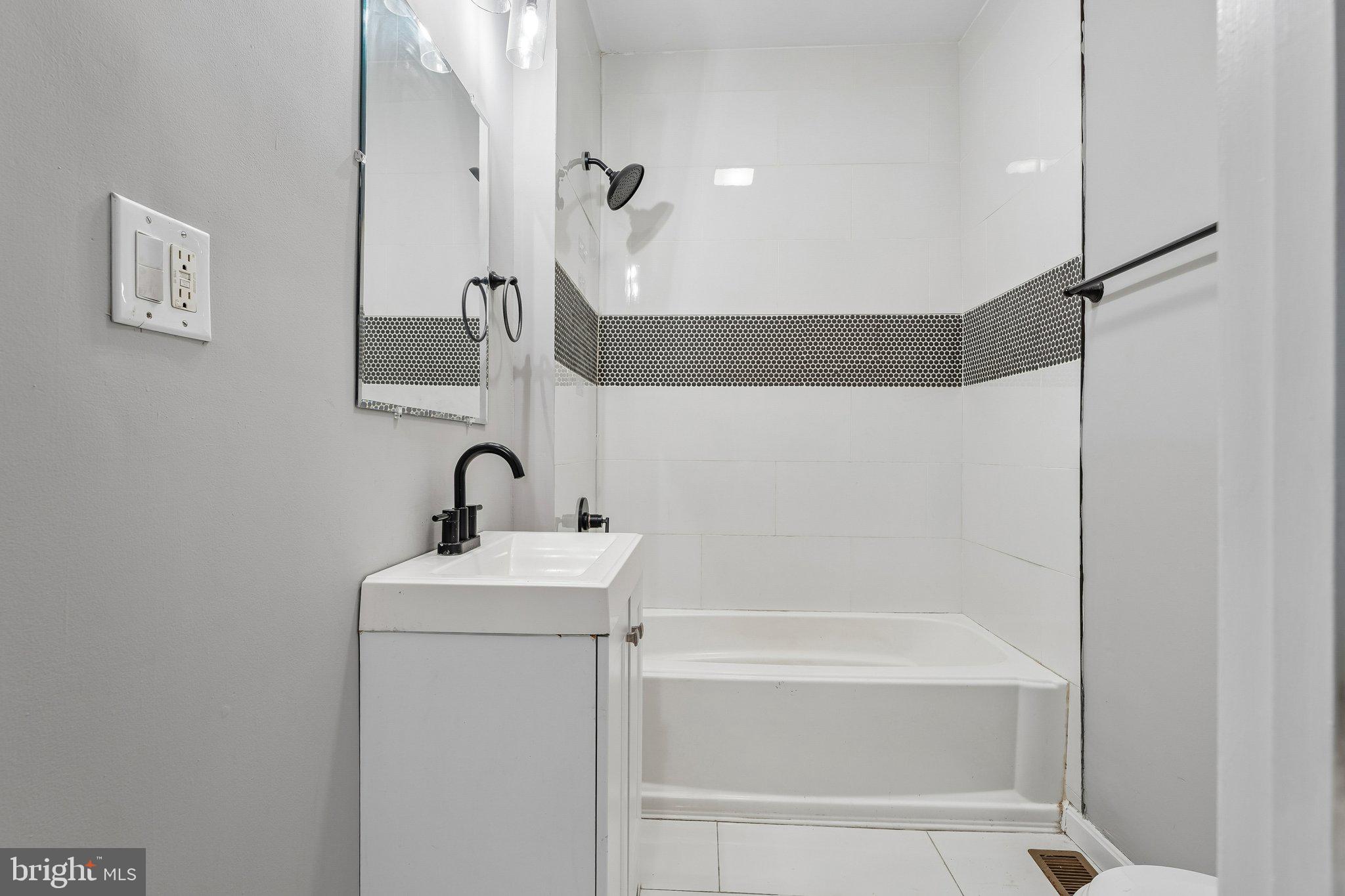 2817 Pelham Avenue Baltimore, MD 21213 - Photo 16 of 25 a bathroom with a bathtub and a sink
