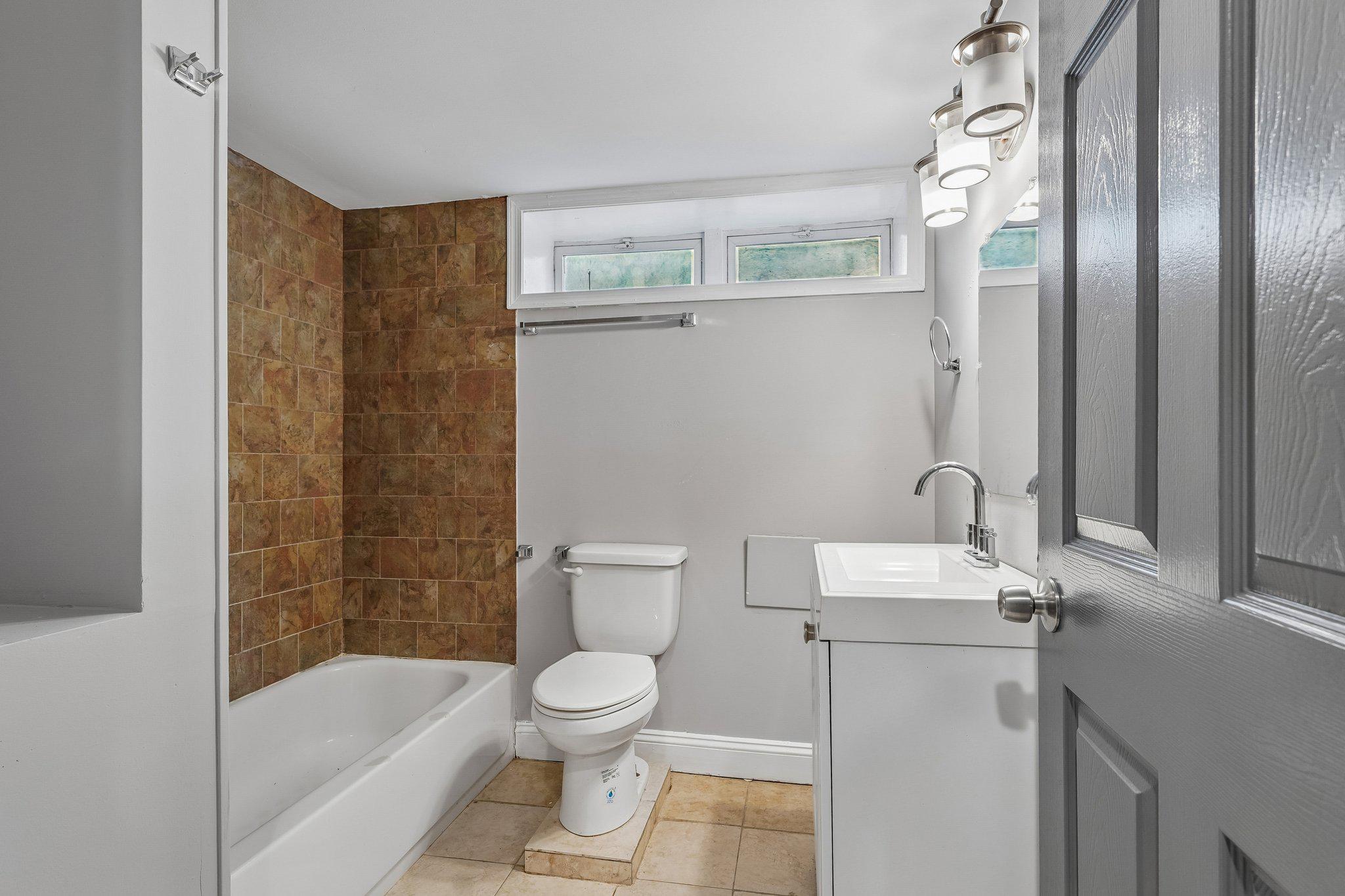 2817 Pelham Avenue Baltimore, MD 21213 - Photo 22 of 25 a bathroom with a sink a toilet and shower