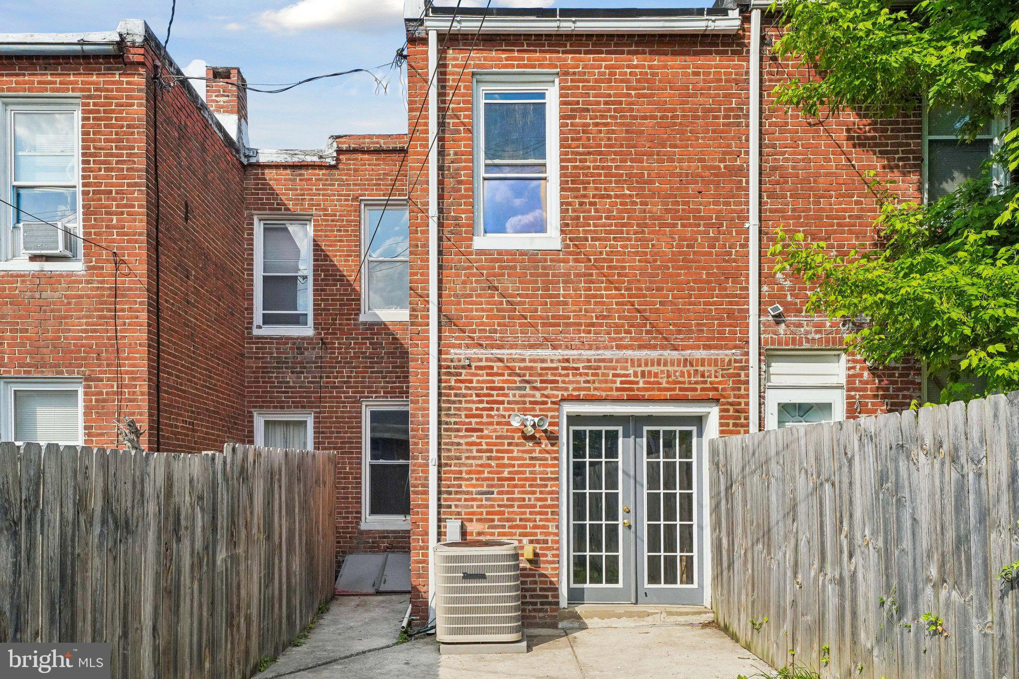 2817 Pelham Avenue Baltimore, MD 21213 - Photo 25 of 25 a view of a brick house with wooden fence