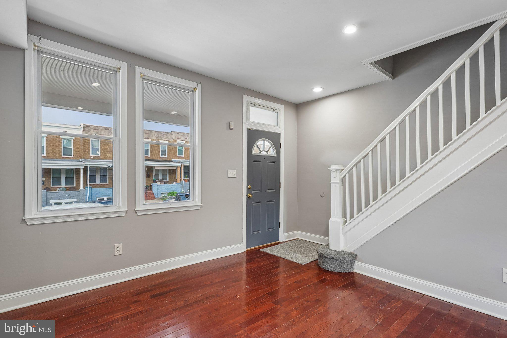 2817 Pelham Avenue Baltimore, MD 21213 - Photo 3 of 25 wooden floor in an empty room with a window