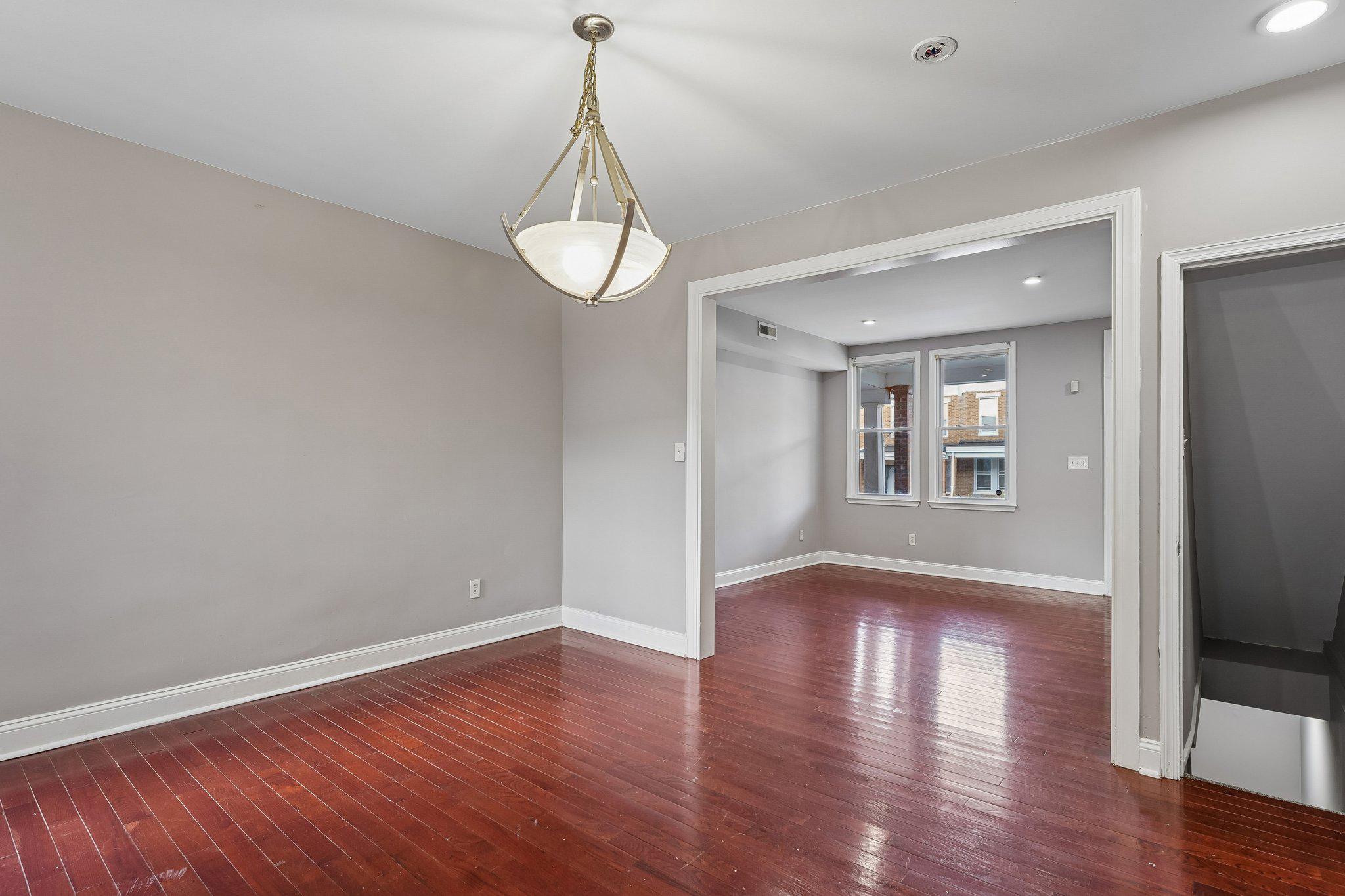2817 Pelham Avenue Baltimore, MD 21213 - Photo 7 of 25 a view of empty room with wooden floor and stove