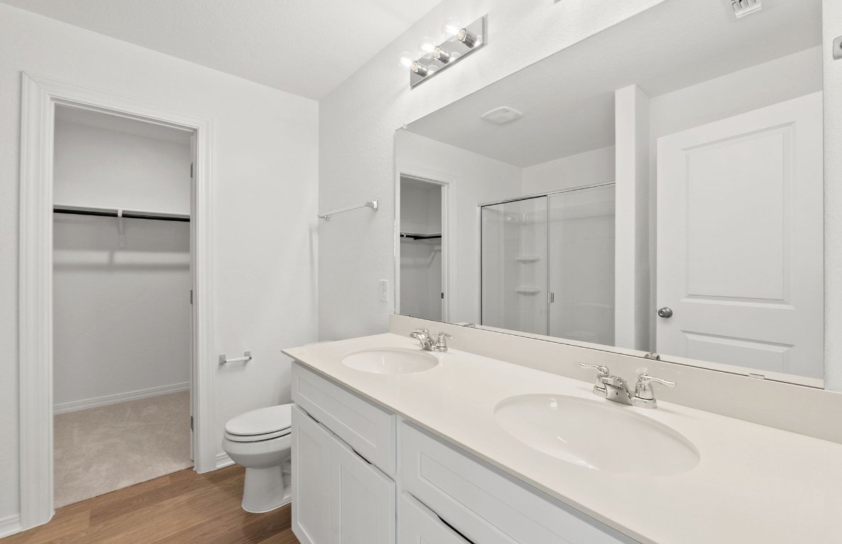 333 Sullivan Way Elgin, TX 78621 - Photo 9 of 18 a bathroom with a granite countertop sink mirror and toilet