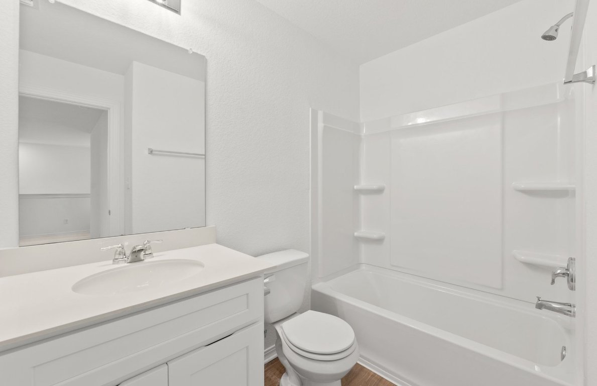 333 Sullivan Way Elgin, TX 78621 - Photo 12 of 18 a bathroom with a sink a toilet and a bathtub