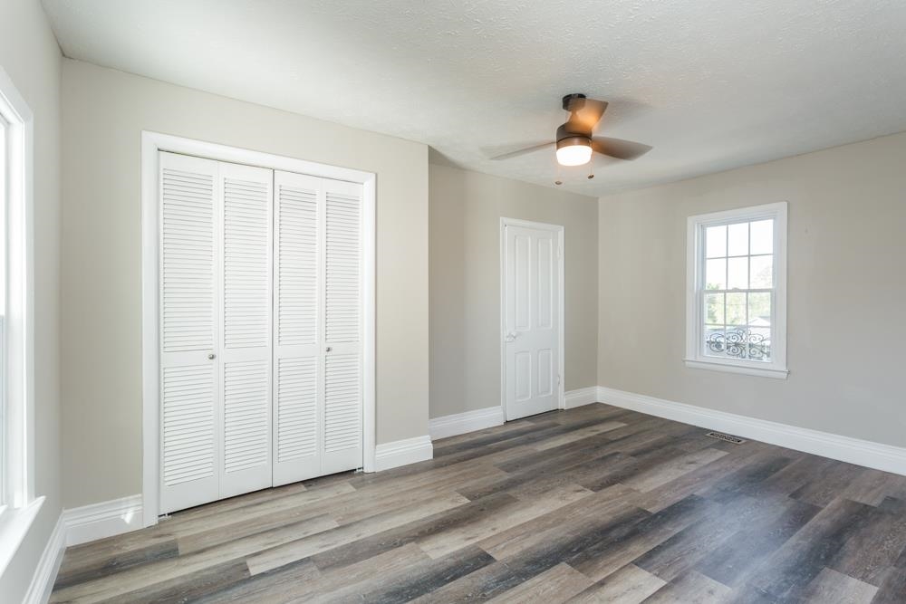 402 5th Street Shenandoah, VA 22849 - Photo 26 of 52 an empty room with wooden floor ceiling fan and windows
