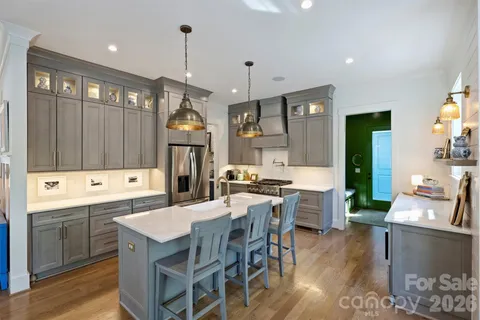 a kitchen that has a table and chairs in it