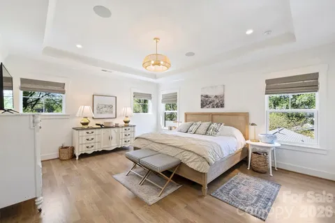 a bathroom with a sink vanity granite tub and a mirror