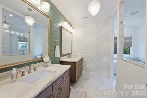 a bathroom with a tub sink shower and mirror