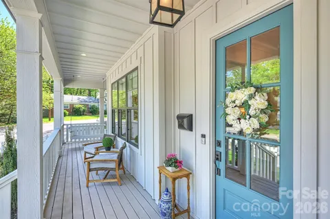 a balcony with furniture and wooden floor