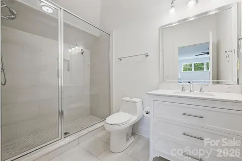 a patio with tables and chairs under an umbrella