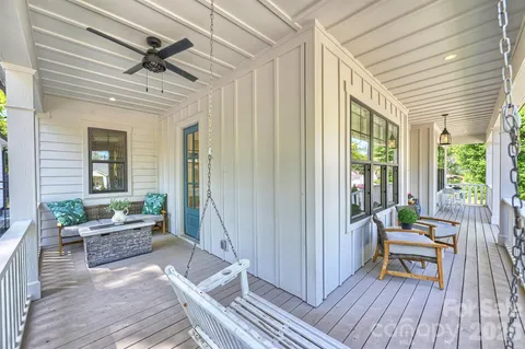 a outdoor space with a large window and wooden floor