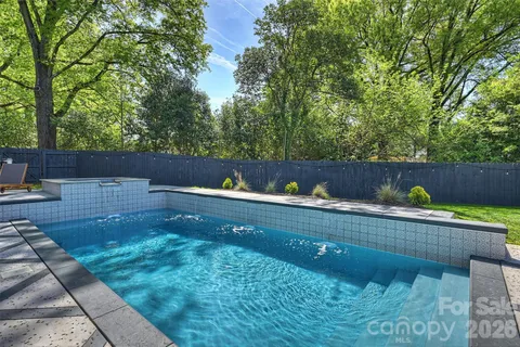 a view of a backyard with sitting area