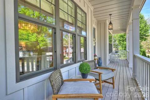 a view of a room that has a bed and a table in it