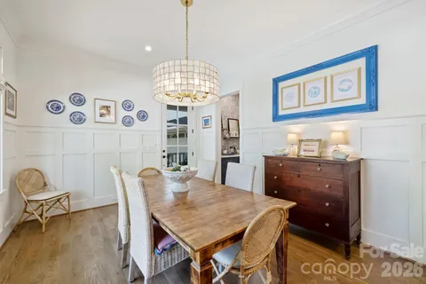 a view of a dining room with furniture and chandelier