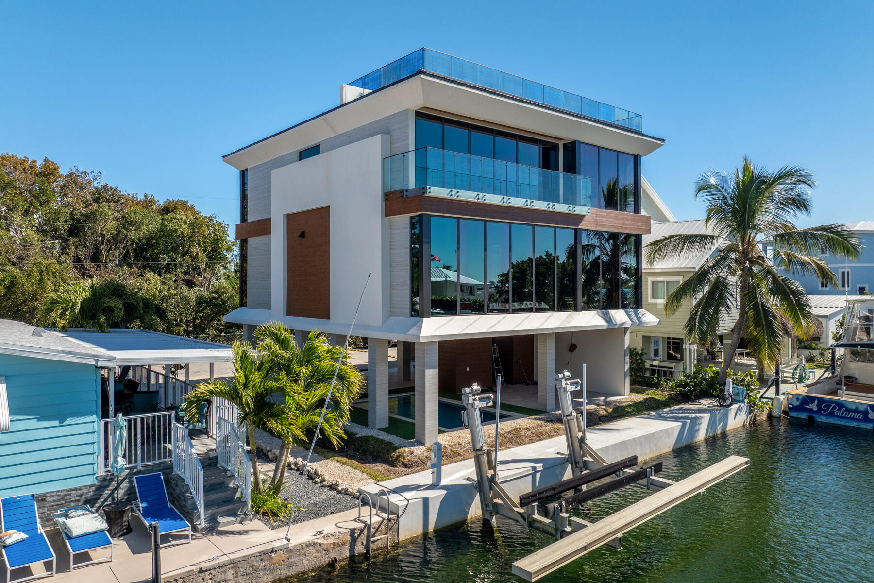 108 Coral Way Key Largo, FL 33037 - Photo 1 of 23 a view of a house with swimming pool and sitting area