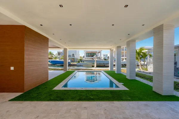 a room with pool table and windows