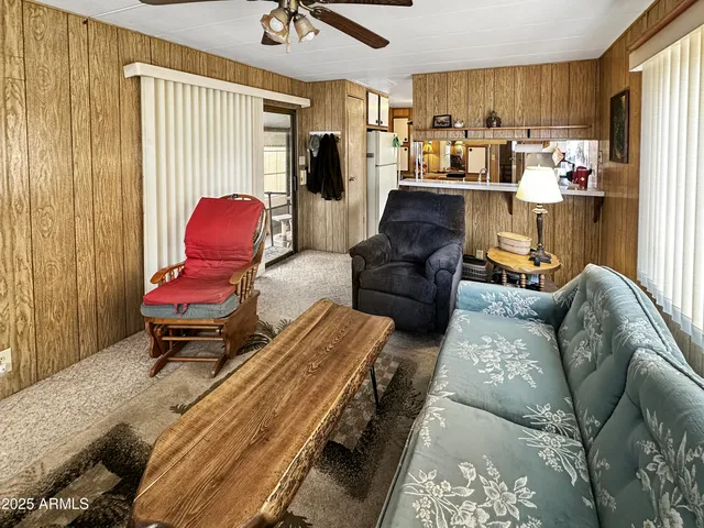 a living room filled with furniture and a chandelier