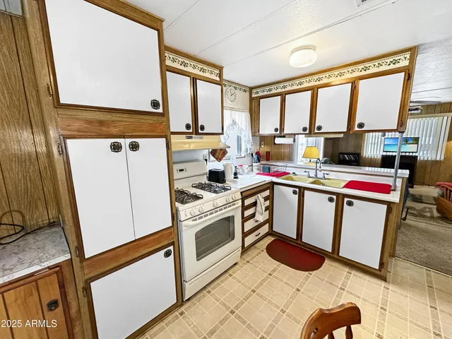 a kitchen with a stove a sink and a refrigerator