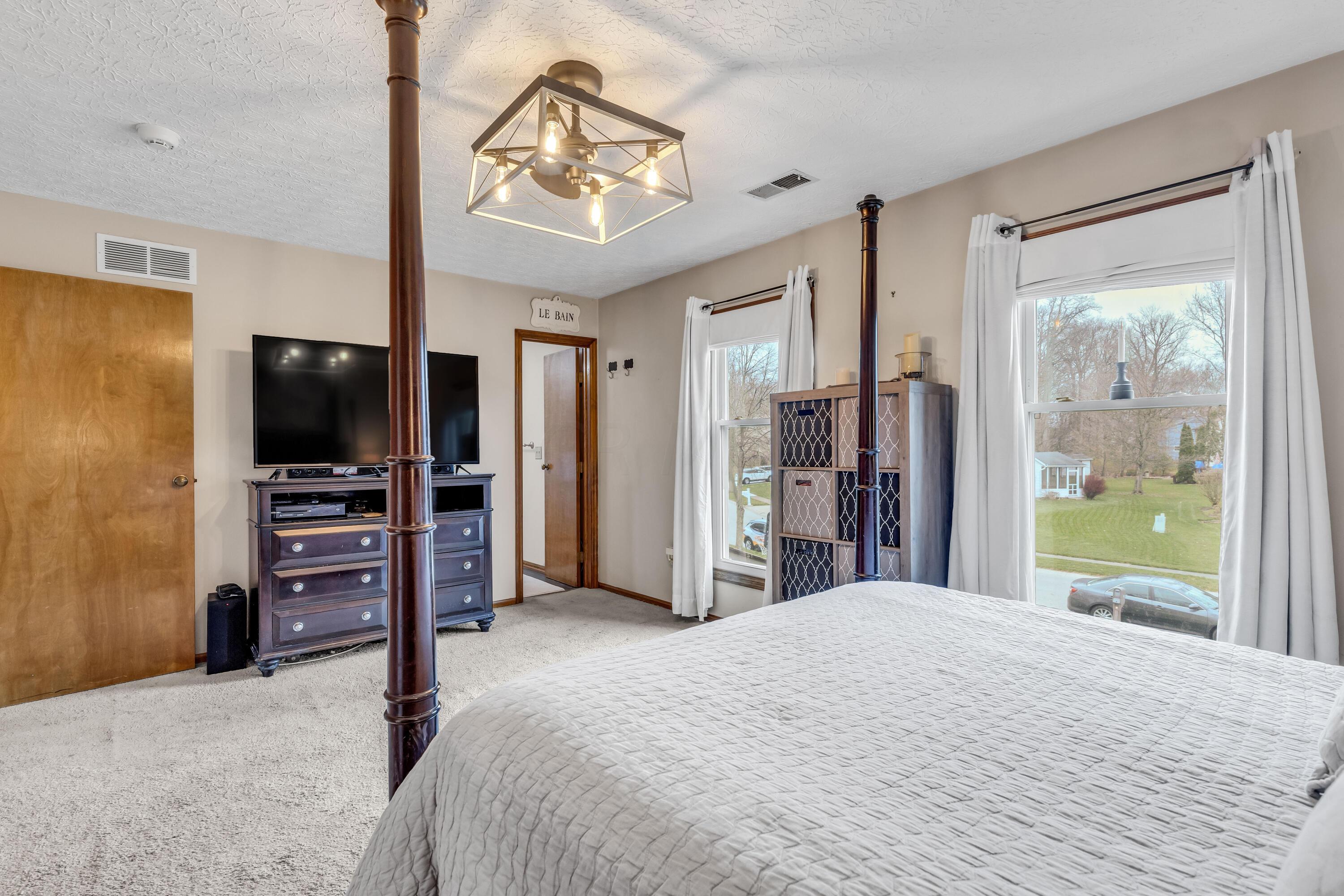 435 Emory Street Gahanna, OH 43230 - Photo 25 of 54 • Light sand carpet
• Tan painted walls
• New lighted ceiling
fan ~ 2023
• His & Her Closets with
double sliding doors
(one with attic access)
• Drapes and shades remain
• Wall shelves are negotiable