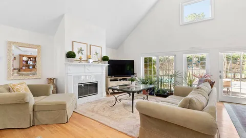 a living room with furniture fireplace and flat screen tv