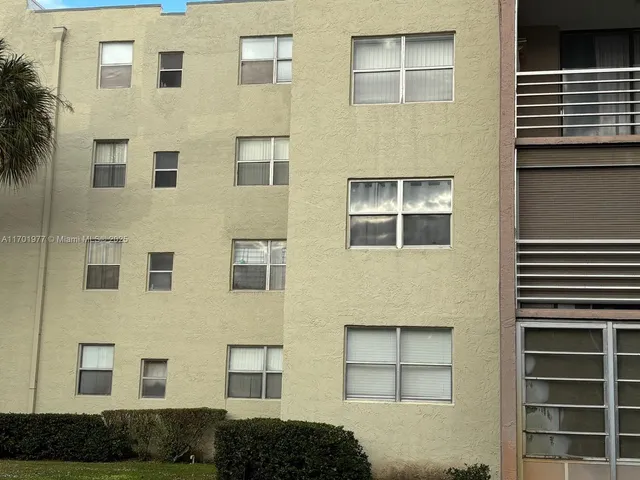 a view of a hallway with front of a house