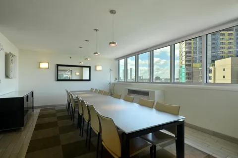 a view of a dining room with furniture and a window