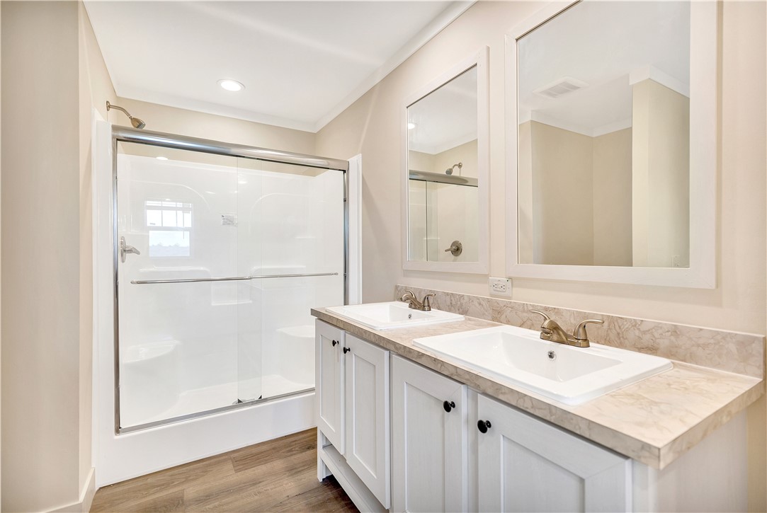 205 Wade Farm Road Fair Play, SC 29643 - Photo 17 of 23 A spacious double vanity and enclosed shower highlight this modern primary bathroom.