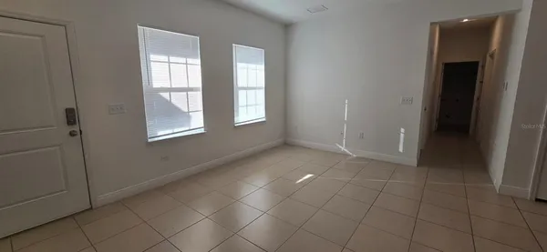 an empty room with windows and closet