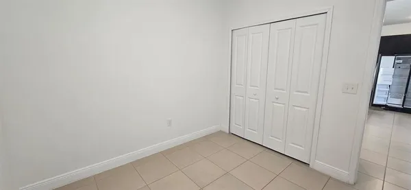 a view of a closet area with wooden floor