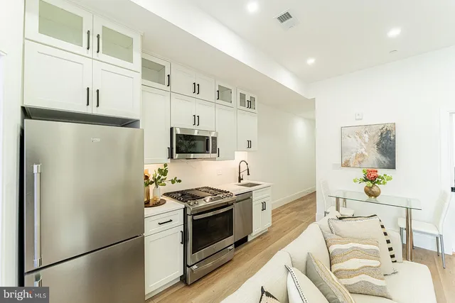 a kitchen with stainless steel appliances a refrigerator stove and sink