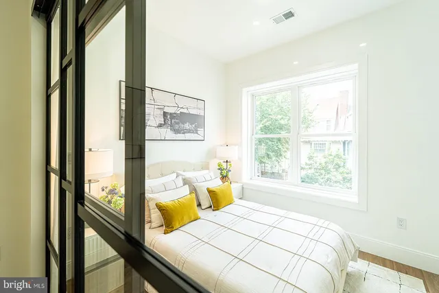 a bedroom with a bed and a window