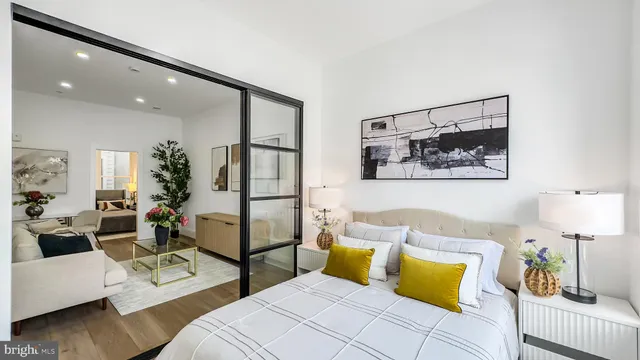 a bedroom with furniture and wooden floor