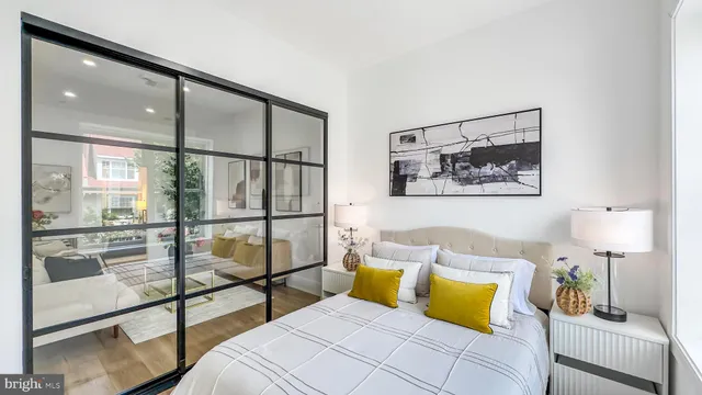 a bedroom with a bed and glass door
