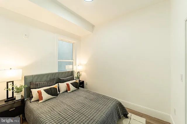 a bedroom with a bed and a night stand