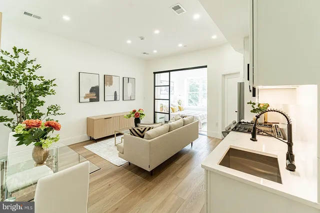 a living room with furniture and flowers