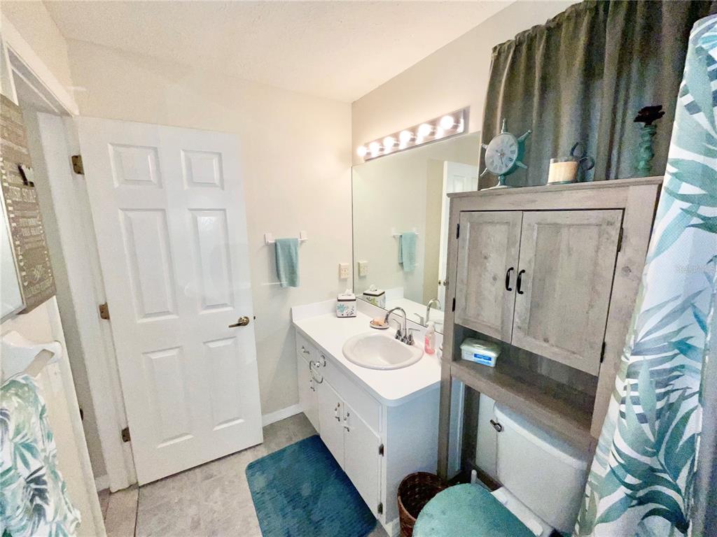 7831 Barclay Road New Port Richey, FL 34654 - Photo 17 of 34 a bathroom with a sink a mirror and a shower