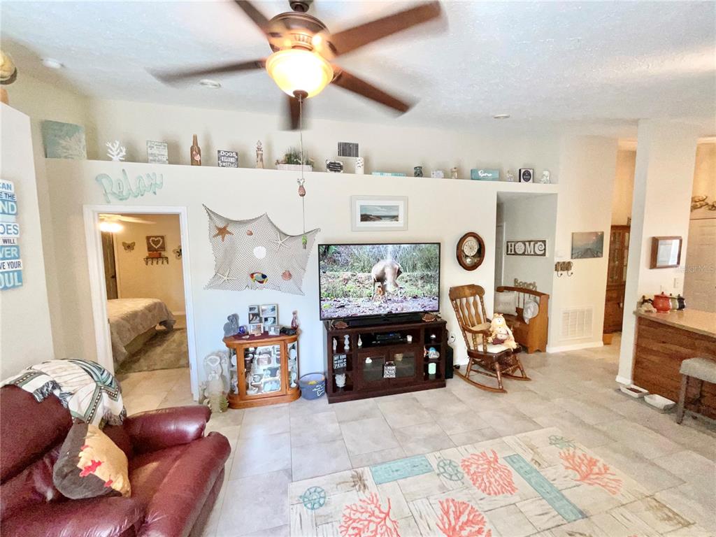 7831 Barclay Road New Port Richey, FL 34654 - Photo 26 of 34 a living room with furniture and a flat screen tv