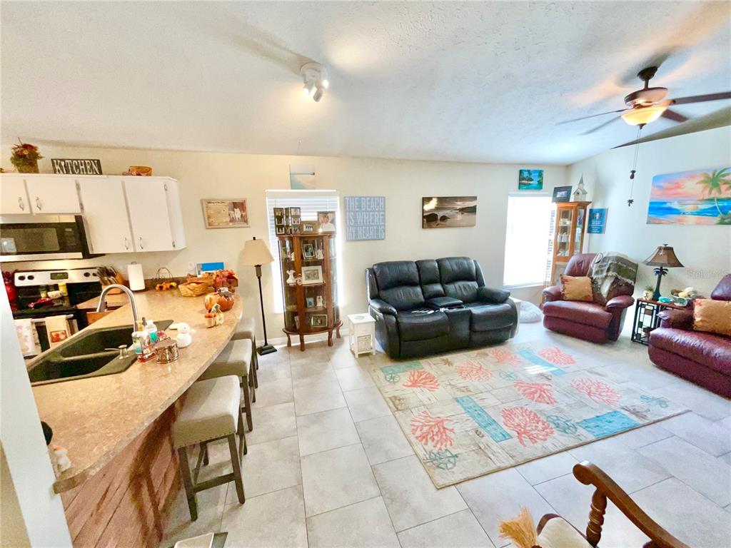 7831 Barclay Road New Port Richey, FL 34654 - Photo 27 of 34 a living room with furniture and a flat screen tv