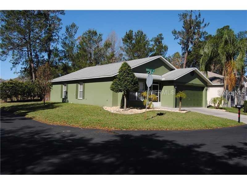 7831 Barclay Road New Port Richey, FL 34654 - Photo 29 of 34 a view of a big house with a big yard and palm trees