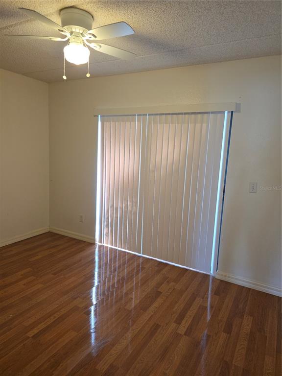 1601 Big Tree Road, Unit 901 Daytona Beach, FL 32119 - Photo 24 of 68 an empty room with wooden floor fan and windows