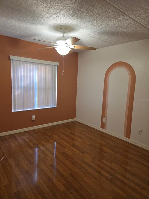 1601 Big Tree Road, Unit 901 Daytona Beach, FL 32119 - Photo 25 of 68 a view of an empty room with wooden floor and a window