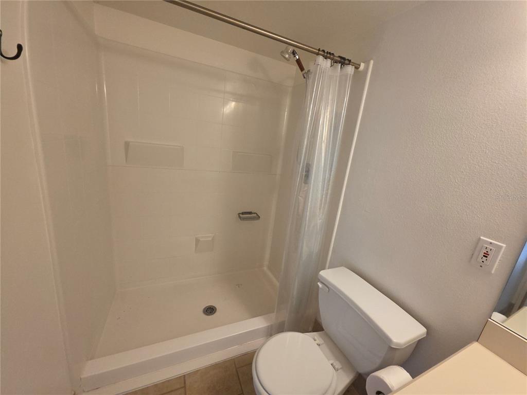 1601 Big Tree Road, Unit 901 Daytona Beach, FL 32119 - Photo 30 of 68 a bathroom with a shower and a toilet