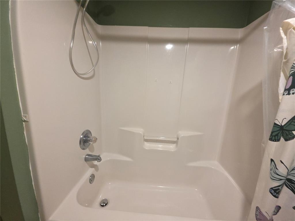 1601 Big Tree Road, Unit 901 Daytona Beach, FL 32119 - Photo 32 of 68 a bathroom with a white bath tub and a shower